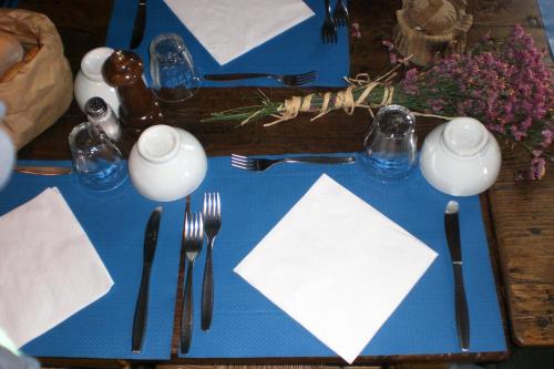 a blue table with utensils on a blue table at Agriturismo Al Marnich in Schignano