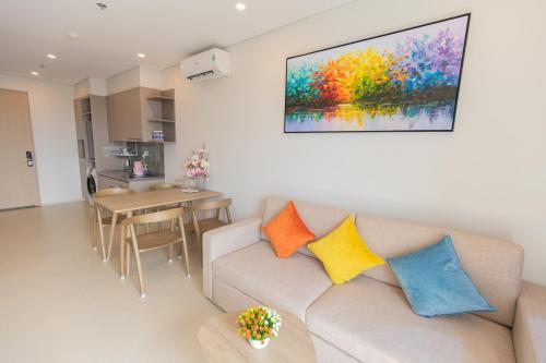 a living room with a couch with colorful pillows at The Song Luxury Condotel Vung Tau - Căn hộ cao cấp Luca's House in Vung Tau