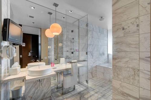 a large bathroom with a sink and a shower at Strip View Luxury Studio No Resort Fee Palms Place in Las Vegas