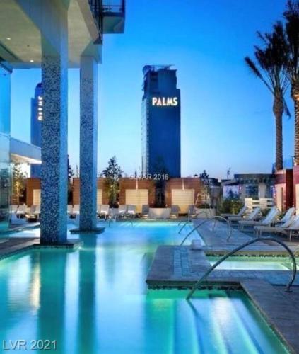 a swimming pool with a hotel in the background at Strip View Luxury Studio No Resort Fee Palms Place in Las Vegas