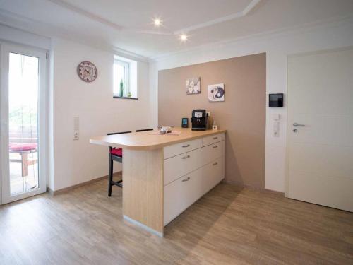 a room with a kitchen with a table and a door at Ferienhaus Müller in Merzig