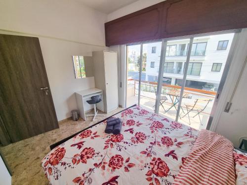 una camera con un letto con una coperta rossa e bianca di Luxury City Rooms a Larnaka