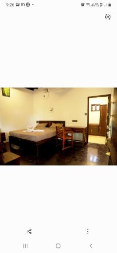a room with a table and some chairs and a table at Jeevan Homestay & Ayurvedic Yoga Retreat in Kovalam