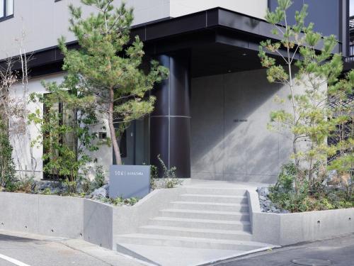 a staircase in front of a building with trees at SOKI Kanazawa in Kanazawa