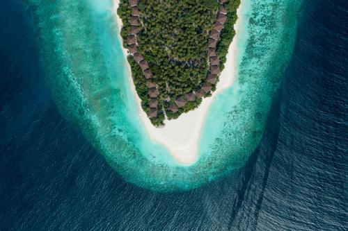 an island with a heart shaped island in the ocean at Avani Plus Fares Maldives Resort - 50 percent off on Seaplane transfer for stays until 22 December 2024 in Baa Atoll