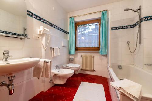 a bathroom with a sink and a toilet and a shower at Cesa Valeria App Monika in Ortisei