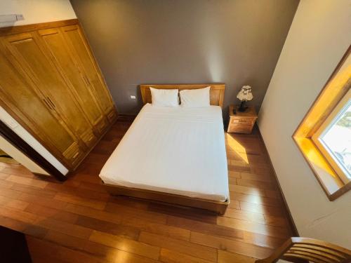 a small bedroom with a bed in a room at HANA Stay Riverside in Hanoi