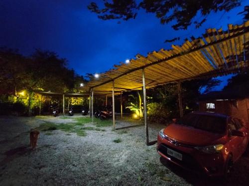 a car parked under a tent at night at Nakabalo Guesthouse & Restaurant in Siquijor
