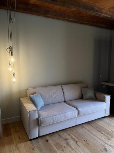 a living room with a couch in a room at Cascina Pianetta Quinta in Missaglia
