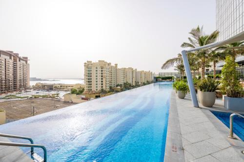 a large swimming pool on top of a building at Ultra Luxury Palm Tower with Shared Hotel Facilities in Dubai