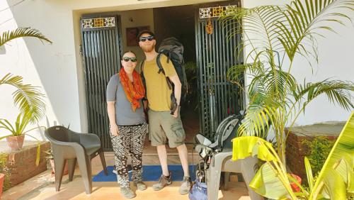 a man and a woman standing in front of a door at The Mountain View Home Stay in Khajurāho