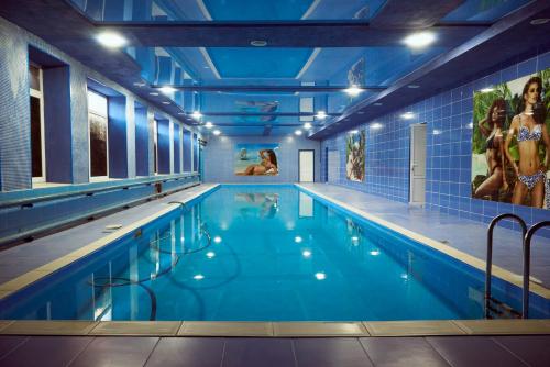 a large swimming pool in a building at Hotel Royal (Отель Роял) in Poltava