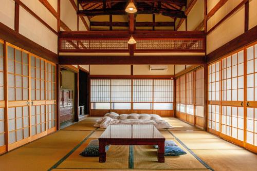 a large room with two beds and a table in it at entohouse BAR&GUESTHOUSE 