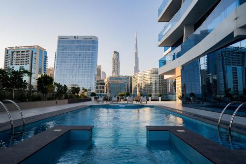 a swimming pool in the middle of a city at Kasco Homes Waves Tower Business Bay in Dubai