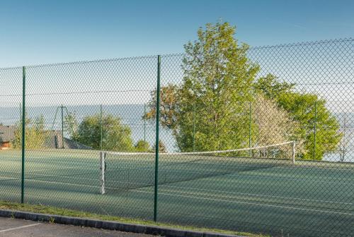 a tennis court with a net on it at Garden & City Evian - Lugrin in Lugrin