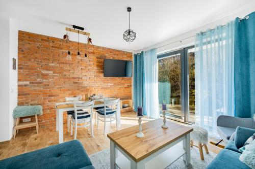 a living room with a brick wall at Apartament Ale Widok in Szczyrk