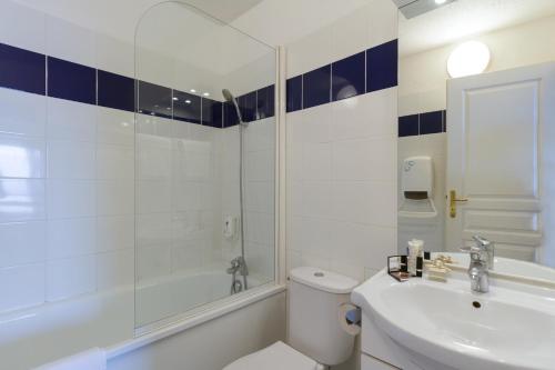 a bathroom with a toilet and a tub and a sink at Garden & City Evian - Lugrin in Lugrin
