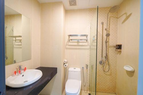 a bathroom with a sink and a toilet and a shower at Avatel Jelutong in George Town