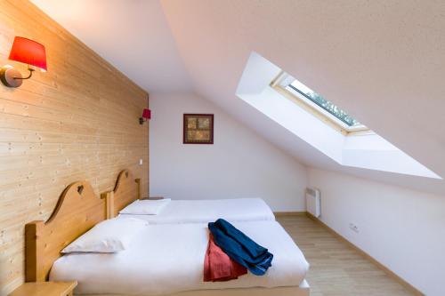 a bedroom with two beds and a skylight at Garden & City Evian - Lugrin in Lugrin