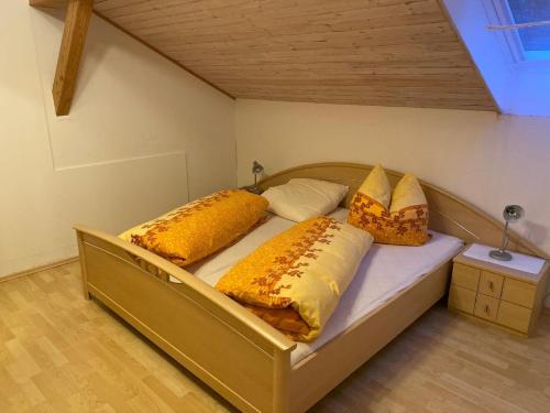 1 dormitorio con 1 cama con 4 almohadas en Ferienhäuser Geiersberg, en Hauzenberg