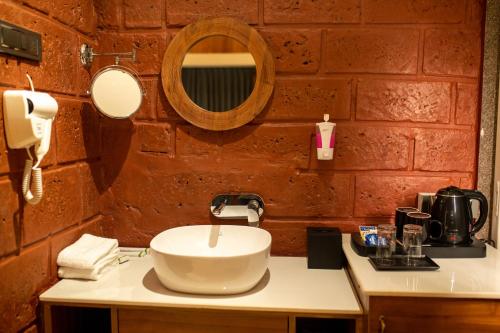 uma casa de banho com um lavatório e um espelho em AATHAVAN MATICHI ECO RESORT em Panhāla