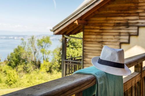 a cowboy hat sitting on a wooden rail on a cabin at Garden & City Evian - Lugrin in Lugrin