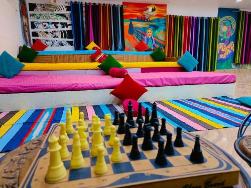 a chess board in front of a room with a couch at Gypsy Diaries Varanasi in Varanasi