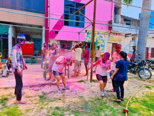 a group of people playing in the holi paint at Gypsy Diaries Varanasi in Varanasi