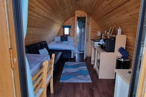 a small room with a bed and a couch in a tiny house at The back pod in Vatsker