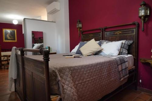 a bedroom with a bed with purple walls at Corte Cantoni in Nonantola