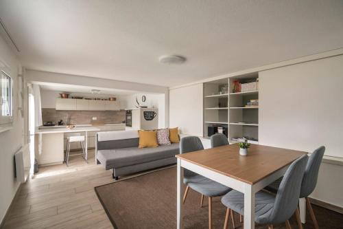 a living room with a table and a couch at Ales Green in Camorino
