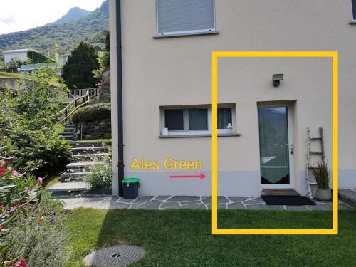 a house with a door with the words aes green at Ales Green in Camorino