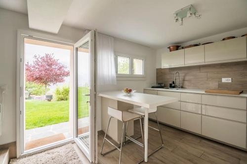 a kitchen with a white counter and a window at Ales Green in Camorino