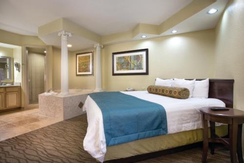 a hotel room with a large bed and a bathroom at Club Wyndham Star Island in Kissimmee