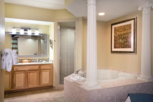 a large bathroom with a tub and a shower at Club Wyndham Star Island in Kissimmee
