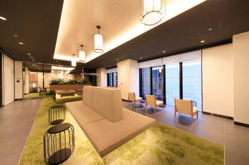 a lobby with a couch and chairs in a building at Via Inn Prime Akasaka in Tokyo