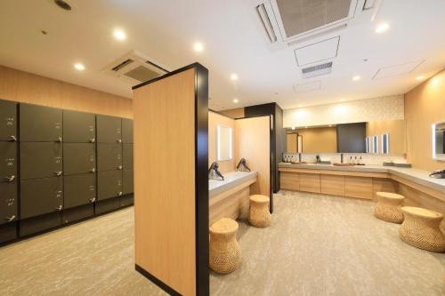 a large dressing room with lockers and a sink at Via Inn Prime Akasaka in Tokyo