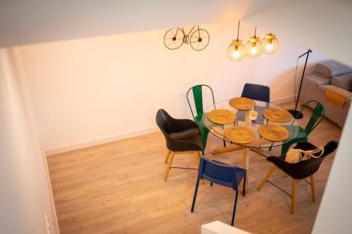 a dining room with a glass table and chairs at Casa de Nero - Premium House with Jacuzzi Next to Golf Course in Caleta De Velez