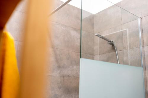 a bathroom with a shower with a glass door at Casa de Nero - Premium House with Jacuzzi Next to Golf Course in Caleta De Velez