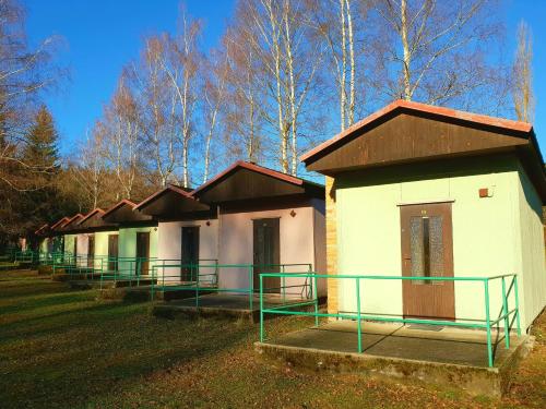 a row of small buildings in a field at Chatový tábor Malý Ratmírov in Malý Ratmírov