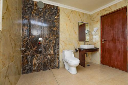 a bathroom with a toilet and a sink at Sky Desert in Leh