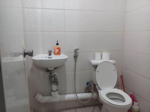 a bathroom with a toilet and a sink at Raljer Homes in Manila