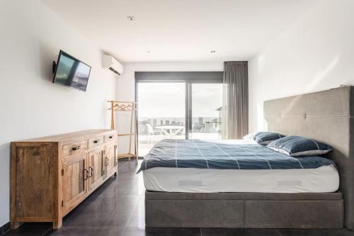 a bedroom with a large bed and a television at Villa in Finestrat in Finestrat
