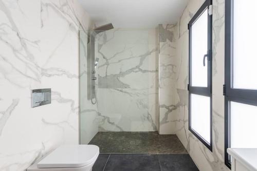 a bathroom with a shower and a toilet and a window at Villa in Finestrat in Finestrat