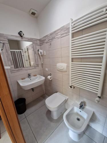 a bathroom with a toilet and a sink at Hotel Bonola in Milan