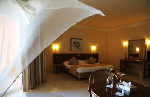 a hotel room with a bed and a window at Hotel Nour Palace Resort & Thalasso Mahdia in Mahdia