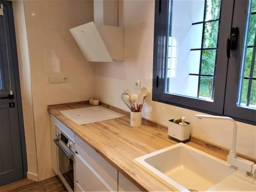 une cuisine avec un comptoir avec un évier et une fenêtre dans l'établissement Casas de Aledo Precioso apartamento con hermosas vistas y jardin, à La Risca