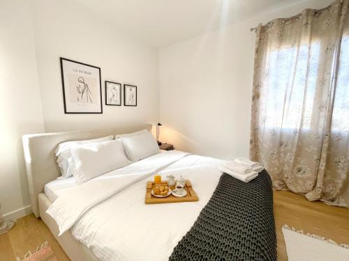 a bedroom with a bed with a tray of food on it at Metro Suites in Tirana