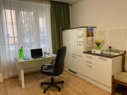 a office with a desk with a laptop on it at Apartment Top Diplomat in Prague
