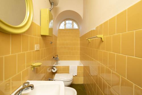 a bathroom with a sink and a toilet and a mirror at Villa Votanidi by VacaVilla in Borgo San Lorenzo